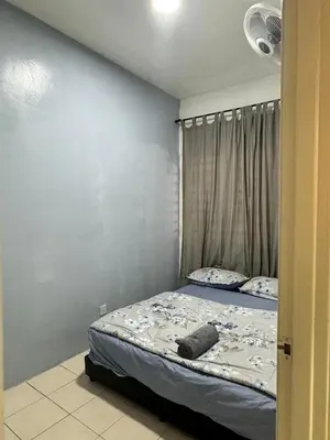 a small bedroom with a bed with a curtain at AYAAN Budget Homestay at Tanah Rata in Tanah Rata