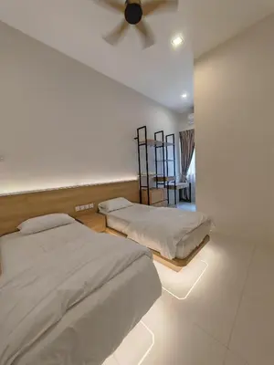 a bedroom with two beds and a ceiling fan at Ipoh M Villa 2 in Ipoh