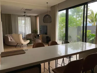 a living room with a table and chairs at Seaview Master Room - Ensuite Bath in Butterworth in Butterworth
