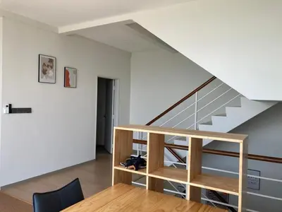 a staircase in a room with a table and a chair at Seaview Master Room - Ensuite Bath in Butterworth in Butterworth