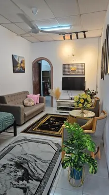a living room with a couch and a table at Rumah Inap Haziq in Seri Manjung