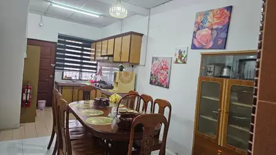 a kitchen with a table and chairs in a room at Rumah Inap Haziq in Seri Manjung