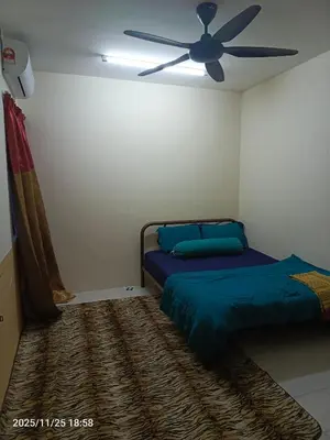 a bedroom with two beds and a ceiling fan at Homestay No 68 Raub in Raub