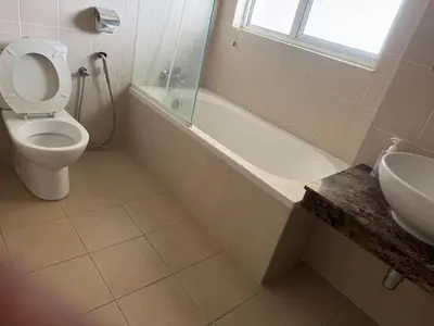 a bathroom with a toilet and a tub and a sink at Deluxe Apartment at CintaSayang Resort in Sungai Petani