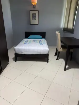 a bedroom with a bed and a table and a desk at Premium Condo at Cinta Sayang Club in Sungai Petani