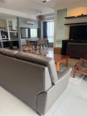 a living room with a couch and a table at Executive Apartment at Cinta Sayang Club in Sungai Petani