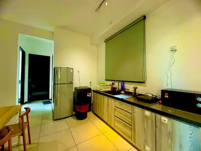 a kitchen with a large projection screen on the wall at urban suites 3 bedroom 10pax a29 in Jelutong