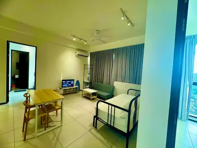 a living room with a couch and a table at urban suites 3 bedroom 10pax a29 in Jelutong