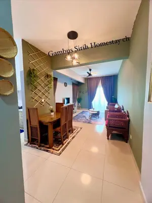 a living room with a table and a couch at Gambus Sireh Homestays in Tanah Rata