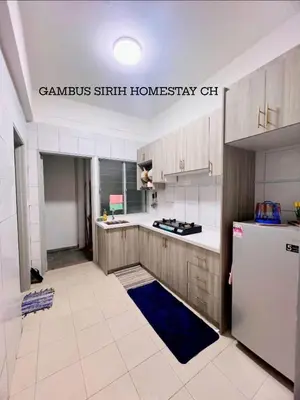 a kitchen with a white refrigerator and a white tile floor at Gambus Sireh Homestays in Tanah Rata