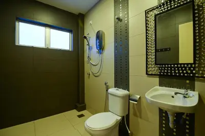 a bathroom with a toilet and a sink and a shower at Parkview Homes in Ipoh