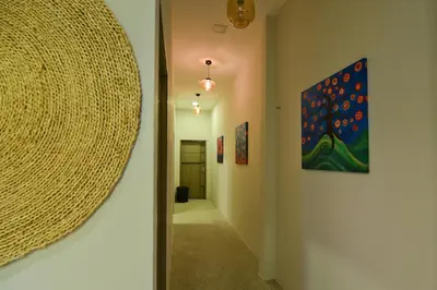 a hallway with a mirror and a painting on the wall at Parkview Homes in Ipoh