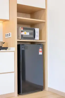 a microwave and a refrigerator in a kitchen at 22 Macalisterz by YourSuperhost in George Town
