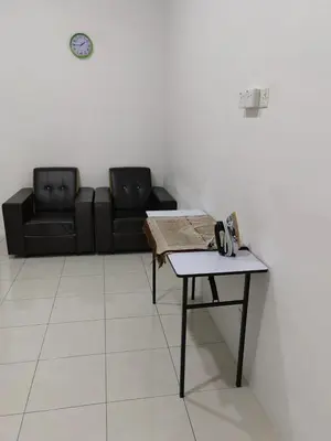 a living room with a couch and a table at Homestay Rumahku Jana in Kamunting