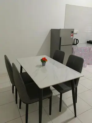 a white table with chairs and a vase of flowers on it at Homestay Rumahku Jana in Kamunting