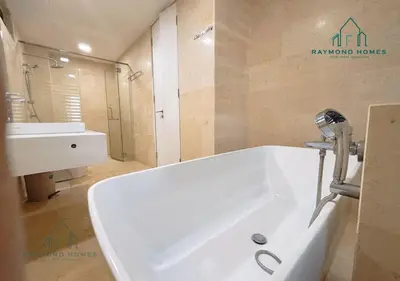 a bathroom with a white tub and a sink at Harborlight Jazz Suite in Tanjong Tokong