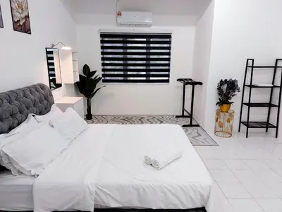 a white bedroom with a bed and a couch at Fz North Meru Impian in Ipoh