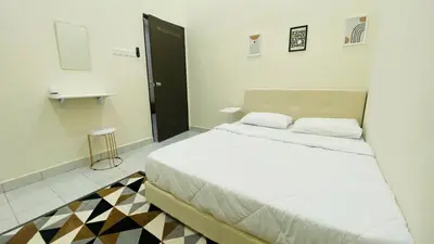 a bedroom with a large bed in a room at Prima Lodge Homestay in Kulim