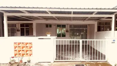 a white house with a gate and a porch at Prima Lodge Homestay in Kulim