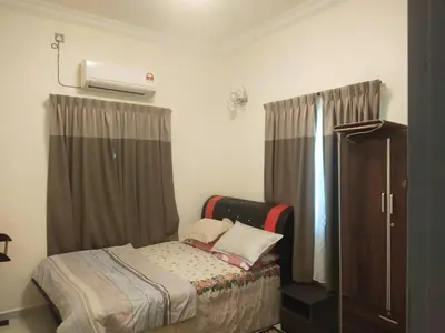 a small bedroom with a bed and a dresser at Teratak Desa Cemerlang 2 in Kuala Kangsar