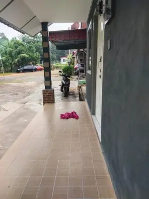 a red shirt on the floor of a building at Teratak Desa Cemerlang 2 in Kuala Kangsar