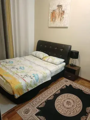 a bedroom with a bed and a rug on the floor at Crown Imperial Court - Arsad Homestay Brinchang in Brinchang