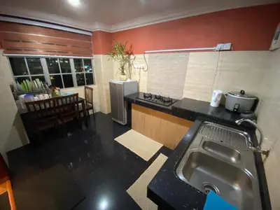 a kitchen with a sink and a counter top at Crown Imperial Court - Arsad Homestay Brinchang in Brinchang