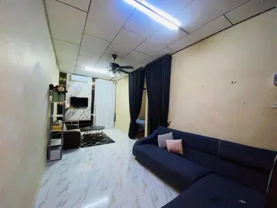 a living room with a blue couch and a ceiling at laman terrace stays in Sungai Petani