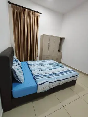 a bed sitting in a room with a window at Bertam Wawasan Homestay in Kepala Batas