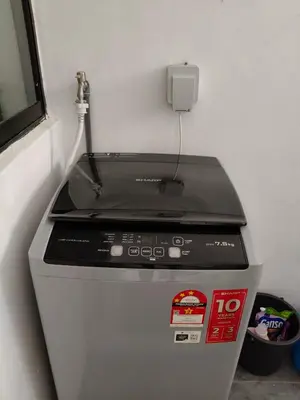 a machine with a charger on top of it at Bertam Wawasan Homestay in Kepala Batas