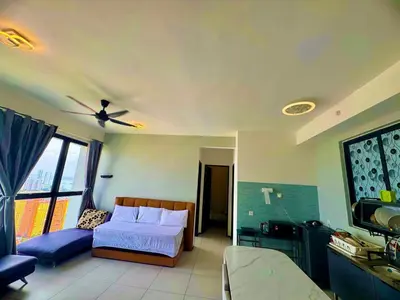 a bedroom with a bed and a flat screen tv at urban suites 3BR 10pax b30 infinity pool in Jelutong