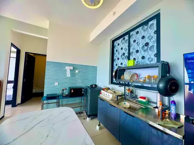 a kitchen with a large window in a room at urban suites 3BR 10pax b30 infinity pool in Jelutong