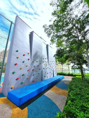 a climbing wall with a blue bench in a park at urban suites 3BR 10pax b30 infinity pool in Jelutong