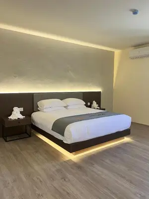 a bedroom with a large bed with lights on it at The Great Hotel Sri Iskandar in Seri Iskandar