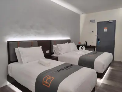a hotel room with two beds in a room at The Great Hotel Sri Iskandar in Seri Iskandar