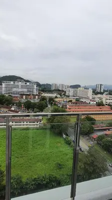 a view of a city with a green field from a window at ICC Suites Ipoh City Center, New & cozy, 6 Pax in Ipoh