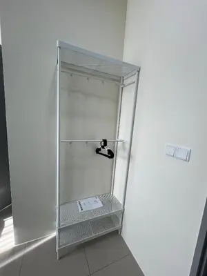 a glass shower stall in a white wall at Cozy Modern Condo with Pool & City Access in Bayan Lepas