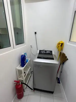 a small kitchen with a stove and a window at Cozy Modern Condo with Pool & City Access in Bayan Lepas