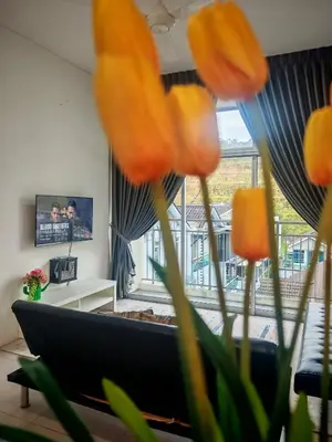 a living room with a couch and a large window at Studio BARRINGTON SQUARE II in Brinchang
