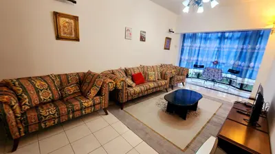 a living room with a couch and a table at Nina's Apt Parkview CH in Tanah Rata