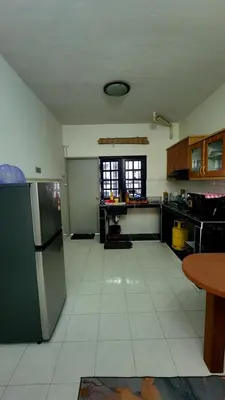 a kitchen with a refrigerator and a table in it at Nina's Apt Parkview CH in Tanah Rata