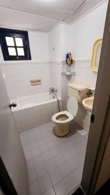 a bathroom with a toilet and a tub and a sink at Nina's Apt Parkview CH in Tanah Rata