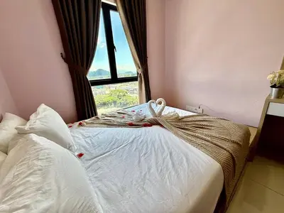 a bed in a room with a window at The Horizon Ipoh Skyline by Grab A Stay in Ipoh