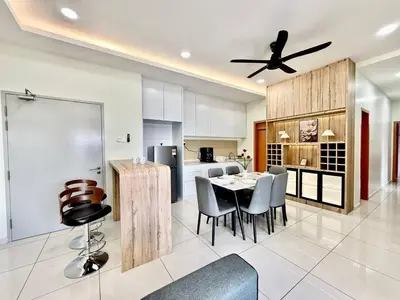 a kitchen and dining room with a table and chairs at The Horizon Ipoh Skyline by Grab A Stay in Ipoh