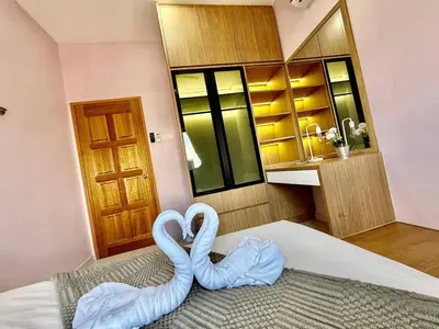 two swans sitting on top of a bed in a room at The Horizon Ipoh Skyline by Grab A Stay in Ipoh