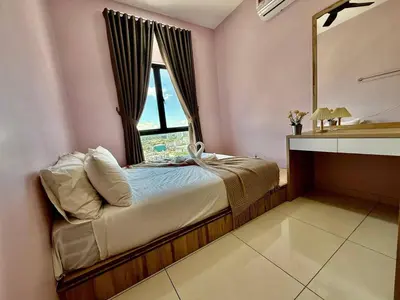 a bedroom with a bed with a mirror and a window at The Horizon Ipoh Skyline by Grab A Stay in Ipoh