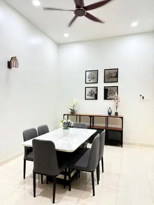 a dining room with a table and chairs and a ceiling fan at Huwayna Private Pool Homestay M U S L I M sahaja in Kepala Batas