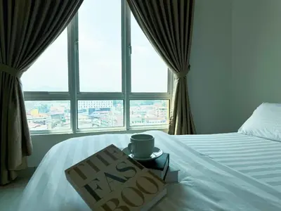 a bed with a happy new year sign in front of a window at IPOH The Majestic Ipoh Town View Fully Air-Con Home in Ipoh