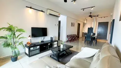 a living room with a couch and a flat screen tv at IPOH The Majestic Ipoh Town View Fully Air-Con Home in Ipoh