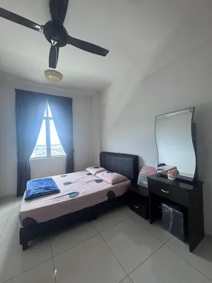 a bedroom with a bed and a mirror and a ceiling fan at BG Roomstay in Ipoh